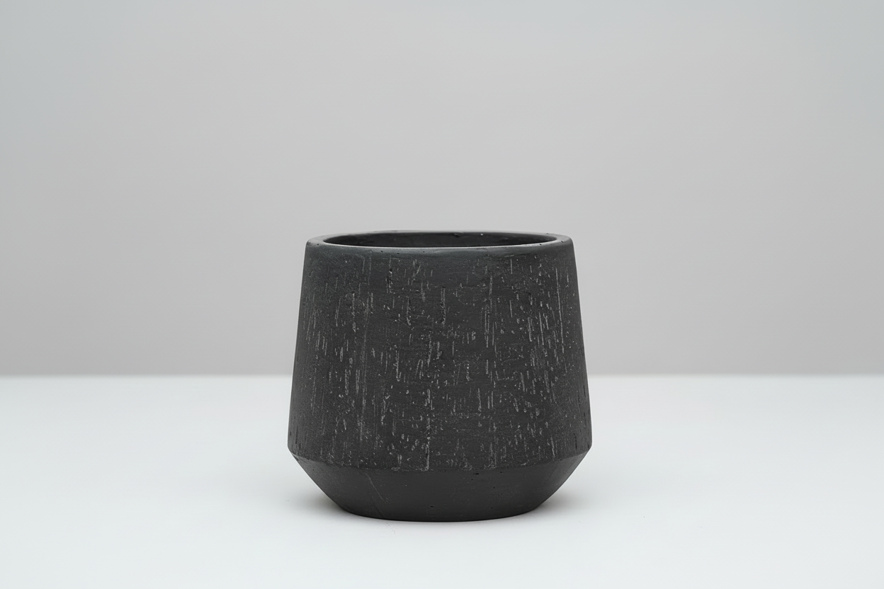Textured black pot on a white background
