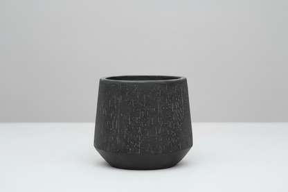 Textured black pot on a white background